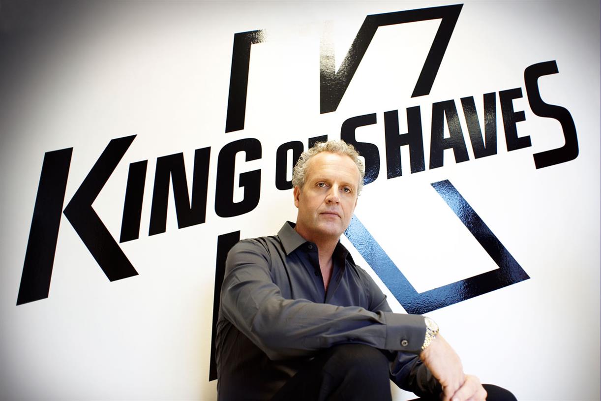 King of Shaves' founder Will King in front of the King of Shaves logo